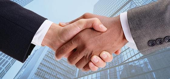 Close-up of a handshake between two business professionals in formal suits
