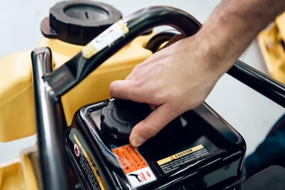 Hand tightening a fuel cap on machinery