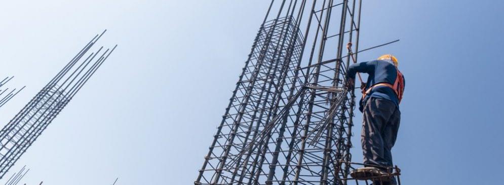 Construction worker securing rebar