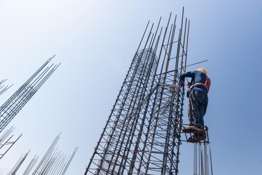 Construction worker securing rebar