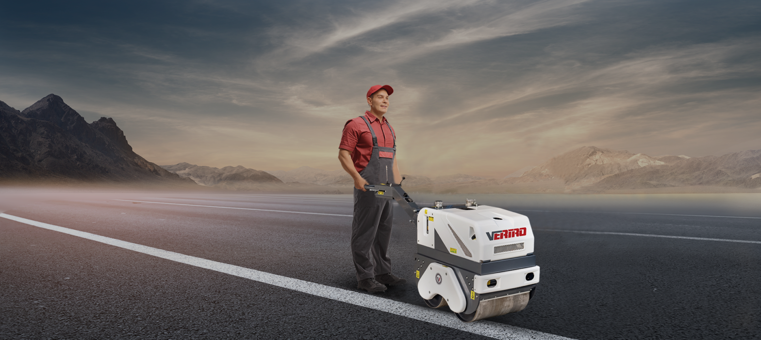 A construction worker operating a Vertro branded compact road roller